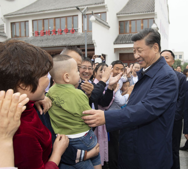 Xi Jinping, general secretary of the Communist Party of China Central Committee, talks with locals at a village in Guangshan county, Henan province on Tuesday, September 17, 2019. [Photo: Xinhua]