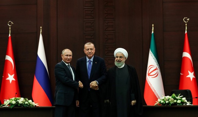 Turkish President Recep Tayyip Erdogan (C), Russian President Vladimir Putin (L) and Iranian President Hassan Rouhani (R) pose for photographs during a press conference following a trilateral meeting on Syria, in Ankara on September 16, 2019. [Photo: AFP/Adem Altan]