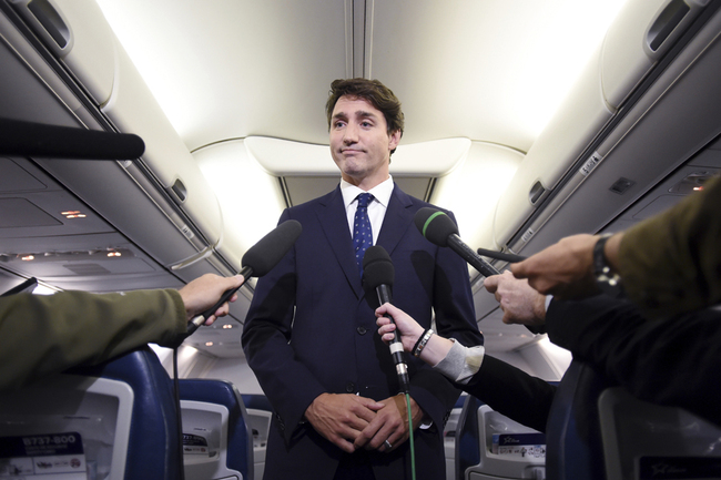 Canadian Prime Minister and Liberal Party leader Justin Trudeau makes a statement in regards to a photo coming to light of himself from 2001, wearing "brownface," during a scrum on his campaign plane in Halifax, Nova Scotia, on Wednesday, Sept. 18, 2019. [Photo: AP via IC/The Canadian Press/Sean Kilpatrick]