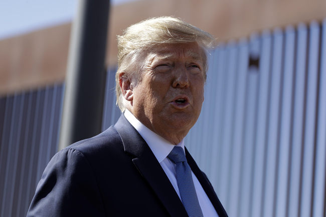 President Donald Trump talks with reporters as he tours a section of the southern border wall, Wednesday, Sept. 18, 2019, in Otay Mesa, Calif. [Photo: AP/Evan Vucci]