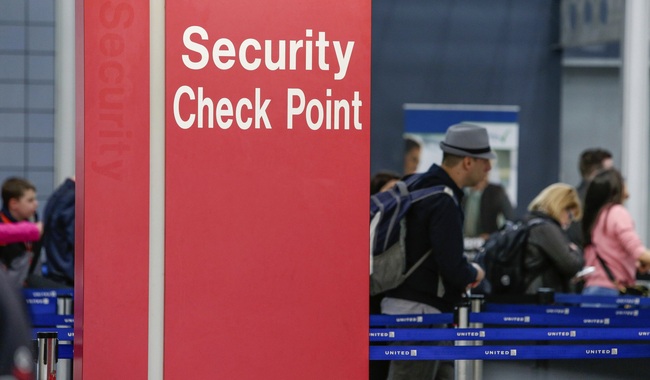 In this March 22, 2016 file photo, passengers check into their flights near a security checkpoint sign at O'Hare International Airport in Chicago. [Photo: AP]