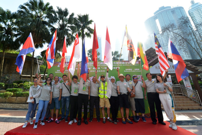 Drivers pose for photos as the competition of the China-ASEAN International Touring Assembly ends in Johor Bahru, Malaysia on Sep 25, 2019. [Photo provided to China Plus]