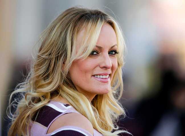 In this Oct. 11, 2018, file photo, adult film actress Stormy Daniels attends the opening of the adult entertainment fair 'Venus' in Berlin, Germany. Ohio’s capital city has reached a $450,000 settlement with Stormy Daniels over the porn actress’ arrest at a strip club last year. Her federal defamation lawsuit against several Columbus officers alleged officers conspired to retaliate against her over her claims that she had sex with Donald Trump before he became president. [Photo: AP/Markus Schreiber]