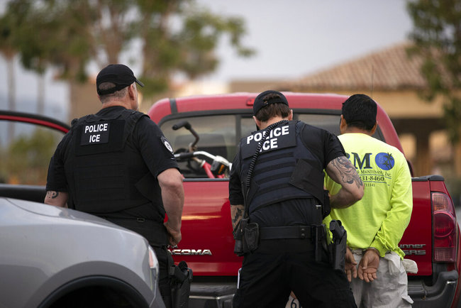 In this July 8, 2019, file photo, U.S. Immigration and Customs Enforcement (ICE) officers detain a man during an operation in Escondido, Calif. [File photo: AP]