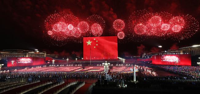 Fireworks sprout from the eastern and western ends of Tian'anmen Square and converge in the night sky in Beijing on Tuesday, October 1, 2019. [Photo: VCG]