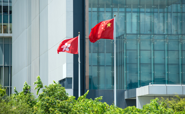 Flags of the People's Republic of China and the Hong Kong Special Administrative Region flutter in front of the buildings in Hong Kong on June 17, 2015. [File Photo: IC]
