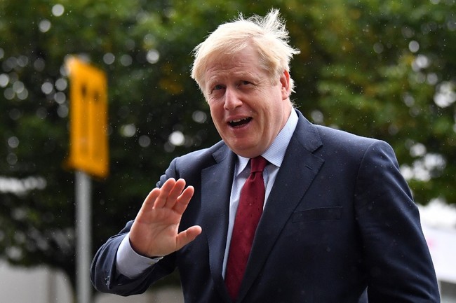 Britain's Prime Minister Boris Johnson returns to his hotel after giving media interviews ahead of the third day of the annual Conservative Party conference in Manchester, north-west England on October 1, 2019. [Photo: AFP]