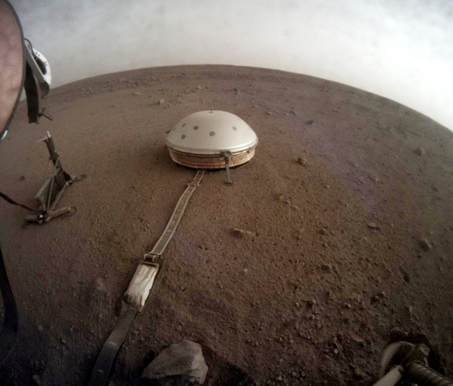 Clouds drift over the dome-covered seismometer, known as SEIS, belonging to NASA's InSight lander, on Mars. [Photo: nasa.gov/JPL-Caltech]