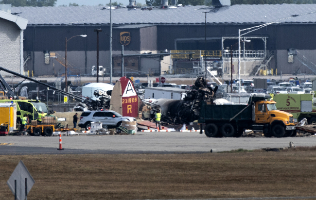 Emergency crews respond to a WWII B-17 bomber crash that happened just before 10 a.m. at Bradley International Airport on Oct. 2, 2019, in Windsor Locks. [Photo: Hartford Courant via IC/Kassi Jackson]