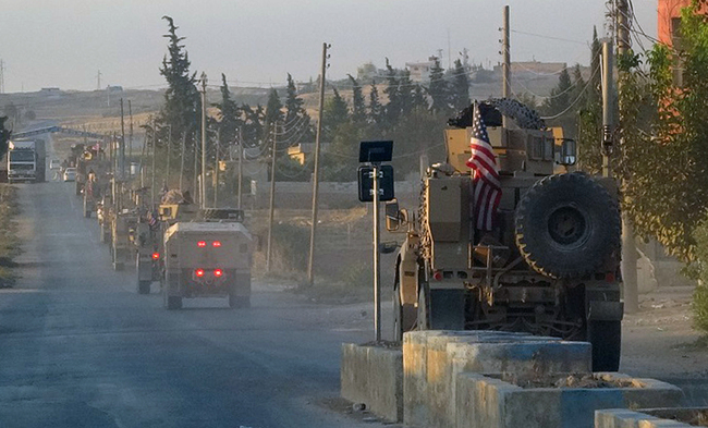 In this image provided by Hawar News Agency, ANHA, U.S. military vehicles travel down a main road in northeast Syria, Monday, Oct. 7, 2019. [Photo: ANHA via AP]