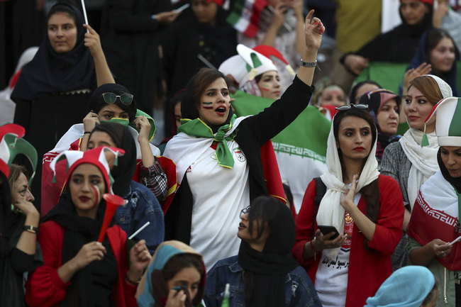 Iranian women cheer during a soccer match between their national team and Cambodia in the 2022 World Cup qualifier at the Azadi (Freedom) Stadium in Tehran, Iran, Thursday, Oct. 10, 2019. [Photo: AP]