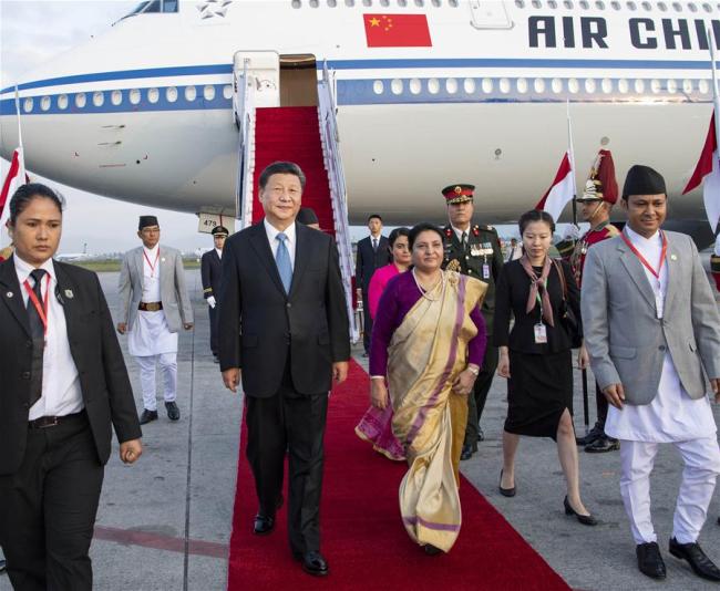 Chinese President Xi Jinping is greeted by Nepali President Bidya Devi Bhandari and her daughter Usha Kiran Bhandari upon his arrival in Kathmandu, Nepal, Oct. 12, 2019. [Photo: Xinhua/Li Tao]
