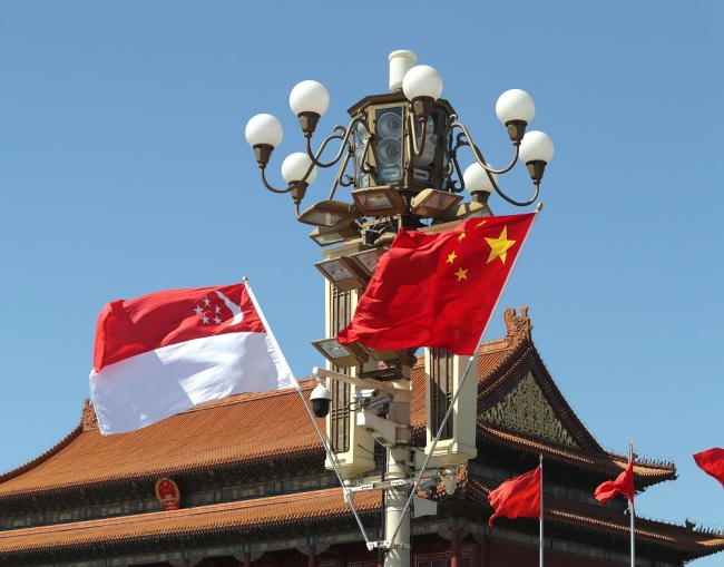 Chinese and Singaporean national flags flutter on the lamppost in front of the Tian'anmen Rostrum. [File Photo: IC]