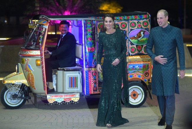 Britain's Prince William (R), Duke of Cambridge, and his wife Catherine, Duchess of Cambridge, arrive on a decorated auto-rickshaw to attend a reception in Islamabad on October 15, 2019. [Photo: AFP]