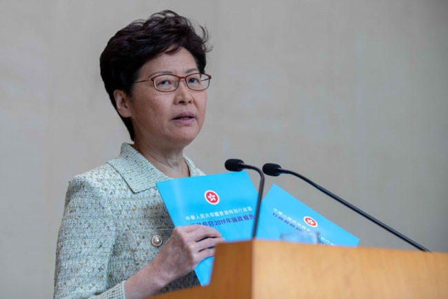 Chief Executive of China's Hong Kong Special Administrative Region Carrie Lam shows the cover of the policy address of the year, which will be released on 16 October, and announces that it conference that will focus on people's welfare, October 15, 2019. [Photo: IC]