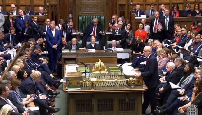 A grab from a handout video made available by the UK Parliamentary Recording Unit shows leader of the Labour Party, Jeremy Corbyn (R) delivering a speech to MPs during a debate at the House of Commons in London, Britain, October 19, 2019. [Photo: IC]