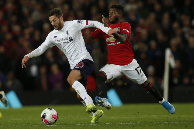 Adam Lallana of Liverpool and Fred of Manchester United during the Premier League match at Old Trafford, Manchester on October 20, 2019. [Photo: IC]