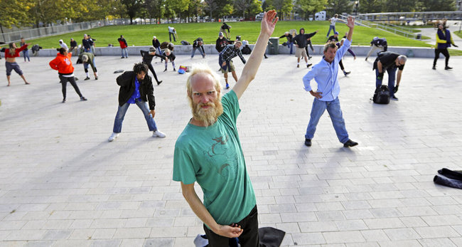 In this Oct. 2, 2019, photo, Whitey Christian performs tai chi at the Salt Lake Main Library, in Salt Lake City. The participants are homeless people who take part in a free tai chi program run by a retired couple who started the classes three years earlier. Now, more than 50 people regularly attend.[Photo: AP]