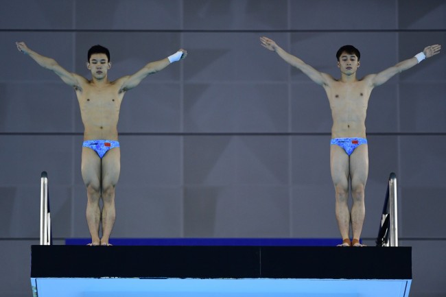 Chinese divers Lian Junjie (R) and Yang Hao in the men's synchronized platform final at the 7th Military World Games in Wuhan, China on Oct 25, 2019. [Photo provided to China Plus]