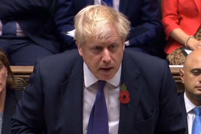 A video grab from footage broadcast by the UK Parliament's Parliamentary Recording Unit (PRU) shows Britain's Prime Minister Boris Johnson standing and speaking at the beginning of a debate (PMQs) and subsequent vote on an Early Parliamentary General Election, in the House of Commons in London on October 28, 2019. [Photo: AFP/PRU/HO]