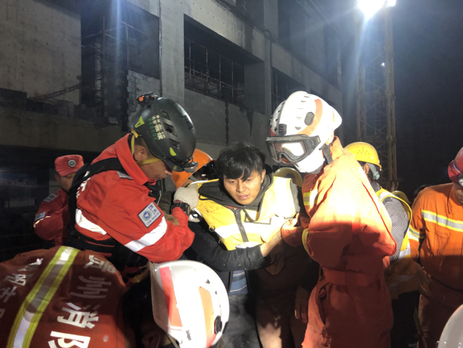 Firefighters found a buried person at the collapsed parking lot in Guiyang city, south-west China's Guizhou province, October 29, 2019. [Photo: IC]