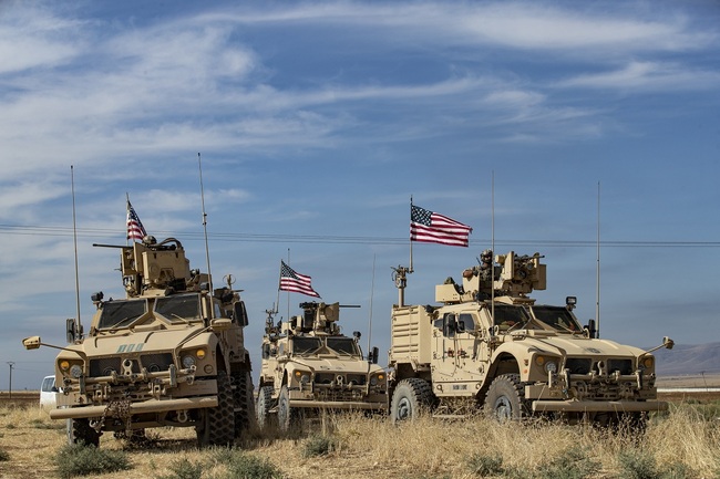 A convoy of US armoured vehicles patrols the northern countryside of the northeastern Syrian town of al-Malikiyah (Derik) at the border with Turkey, on November 3, 2019. [Photo: AFP/Delil SOULEIMAN]