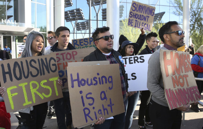 Protesters shout as they hold signs outside Las Vegas City Hall during a protest against the city council's ban on homeless camping on Wednesday, Nov. 6, 2019. [Photo: AP]