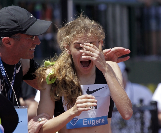 In this June 1, 2013, file photo, Mary Cain, 17, right, reacts as coach Alberto Salazar tells her she has just broken the American high school 800-meter record during the Prefontaine Classic track and field meet in Eugene, Ore. [Photo: AP]