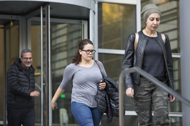 Zeina Abouammo, second left, whose husband Ahmad Abouammo, a US citizen, is accused of using his position at Twitter to spy on accounts, leaves after a detention hearing at US District Court, Western District of Washington, in Seattle on November 8, 2019. [Photo: Jason Redmond/AFP]