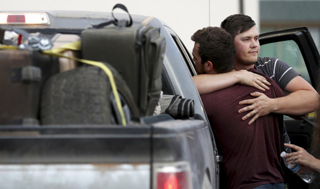 Cole Langford, left, and Hayden Spenct, of the Mormon colony in La Mora, Mexico, hug during a rendezvous in a gas station in Douglas, Ariz., Saturday, Nov. 9, 2019. [Photo: AP]