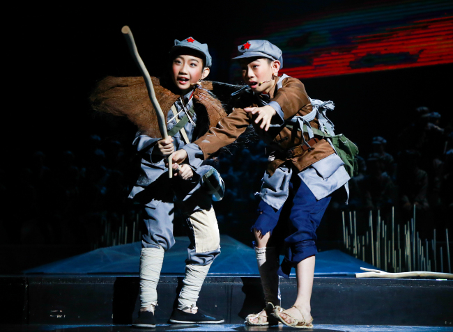 Students in military uniforms perform at the China National Theatre for Children on Nov 21, 2019. Their performance marks the opening of a series of shows that display the accomplishments of drama students in Beijing schools. [Photo provided to China Plus]
