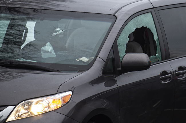 Bullet holes are seen here in the windows of a van in the parking lot of Sarah J. Anderson Elementary School in Vancouver, Wash., following a shooting on Tuesday, Nov. 26, 2019. [Photo: Nathan Howard/The Columbian via AP]