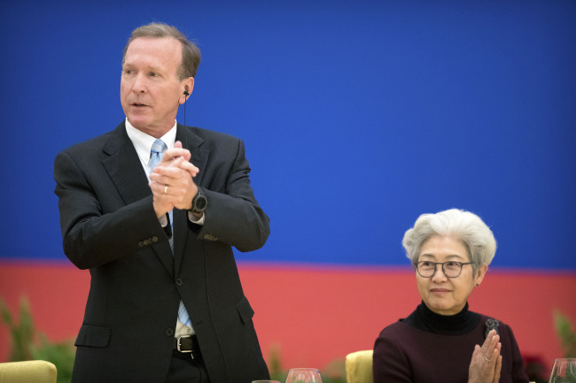FILE - Neil Bush (L), son of former US President George H.W. Bush, is introduced at an event commemorating the 40th anniversary of the establishment of diplomatic relations between the United States and China at the Great Hall of the People in Beijing on January 10, 2019. [Photo: AFP]