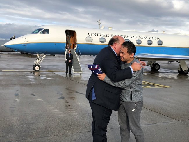 Edward McMullen greets Xiyue Wang in Zurich, Switzerland on Saturday, Dec. 7, 2019. [Photo: U.S. Embassy Switzerland via AP]