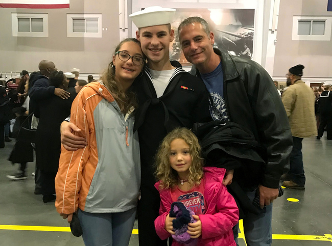 Cameron Walters, center in Navy uniform, poses for a photo with his family. Cameron Walters, 21, was among three sailors killed at Naval Air Station Pensacola in Florida on Friday, Dec. 6. [Photo: Heather Walters/Courtesy of the Walters Family via AP]