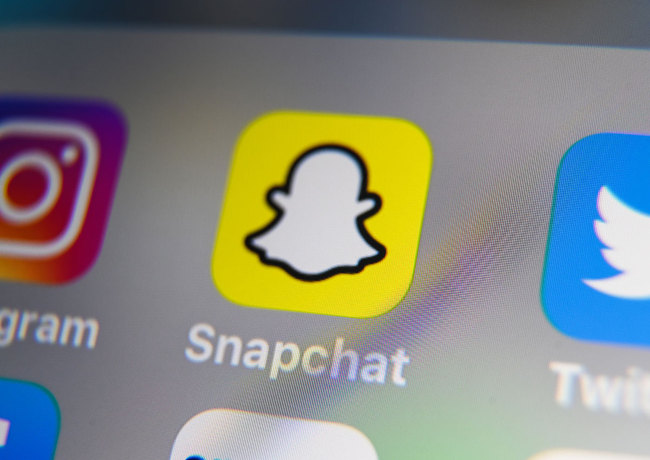 This file photo taken on October 01, 2019 shows the logo of mobile app Snapchat displayed on a tabletin Lilli, France. [Photo: AFP]