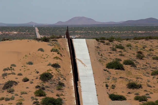 File Photo: This picture taken on August 28, 2019 shows a portion of the wall on the US-Mexico border seen from Chihuahua State in Mexico (L), some 100 km from the city of Ciudad Juarez. [Photo: AFP/HERIKA MARTINEZ]