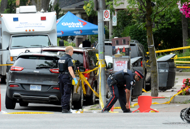 Toronto Police investigate the scene of a shooting from the night before in Toronto, Ontario, Canada on July 23, 2018. [Photo: Usman Khan/AFP]