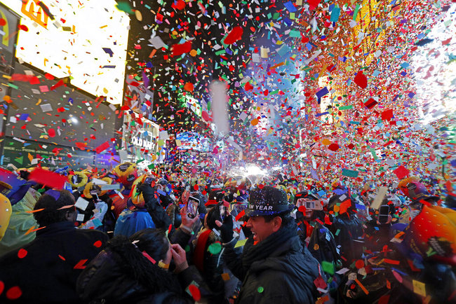 In this Tuesday, Jan. 1, 2019, file photo, Joey Flores, of California, uses his cellphone as confetti falls during a New Year's celebration in New York's Times Square. [File photo: AP]