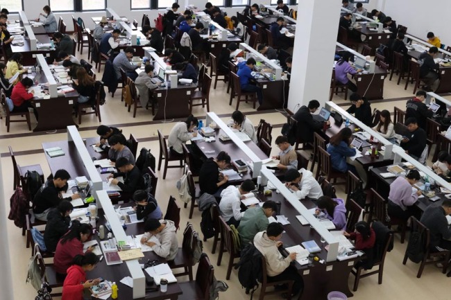 V knihovně na univerzitě v Zhengzhou (Čeng-čou) v provincii Henan (Che-nan) se studenti připravují na přijímací zkoušky. Fotografie: Chen Dong (Čchen Tung) pro China Daily