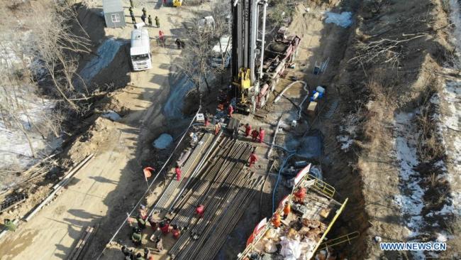Letecký snímek pořízený 17. ledna 2021 ukazuje záchranáře pracující v místě výbuchu zlatého dolu ve městě Qixia (Čchi-sia) ve východočínské provincii Shandong (Šan-tung). Dvacet dva pracovníků bylo uvězněno v podzemí poté, co výbuch roztrhl zlatý důl, který byl ve výstavbě ve východočínské provincii Shandong. Záchranáři vyvrtali ze země díru do tunelu, kde se nacházejí uvěznění pracovníci. (Xinhua / Wang Kai)