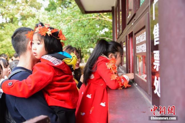 Le 20 octobre, des touristes admirent les feuilles rouges au parc des Collines parfumées (Xiangshan) de Beijing. Avec la chute des températures, les feuilles des arbres des Collines parfumées sont devenues rouges les unes après les autres.
