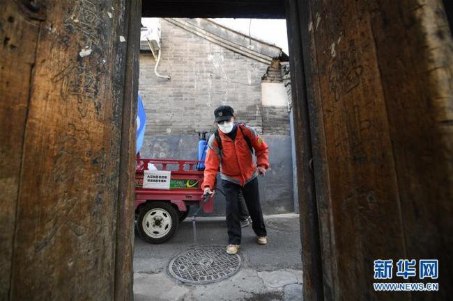 Le volontaire Meng Lianyou mène une opération de désinfection dans un hutong du district de Dongcheng, à Beijing, le 10 mars 2020. Les hutongs de Beijing sont des ruelles étroites traditionnelles et appréciées des touristes, mais elles sont devenus beaucoup plus silencieuses depuis le début de l’épidémie de COVID-19. Des milliers de travailleurs communautaires de base de la capitale chinoise se sont consacrés à la bataille contre le virus. (Photos: Ju Huanzong/Xinhua)