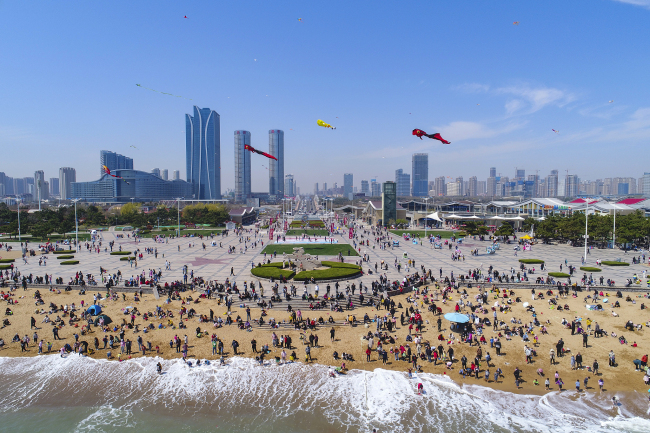 De nombreux touristes sont venus profiter de la mer et de la plage au parc aquatique de Rizhao, dans la province du Shandong (est), le 5 avril 2021. 