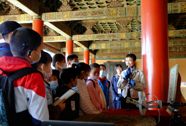 Des adolescents apprennent sur la peinture aux couleurs au Palais impérial