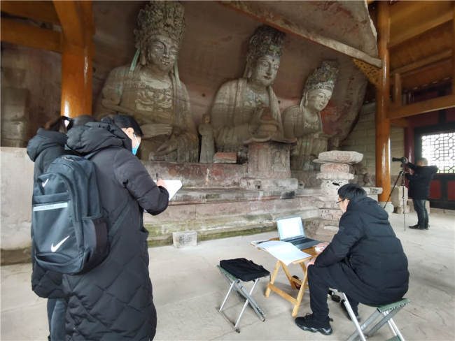 Ερευνητές από την Ακαδημία Γλυπτών των Βράχων Νταζού κάνουν μια λεπτομερή έρευνα του Φοζουγιέν - ή αλλιώς του «βράχου του Βούδα», στο Νταζού τον Δεκέμβριο 2020. [Φωτογραφία από τον Wang Kaihao / China Daily]