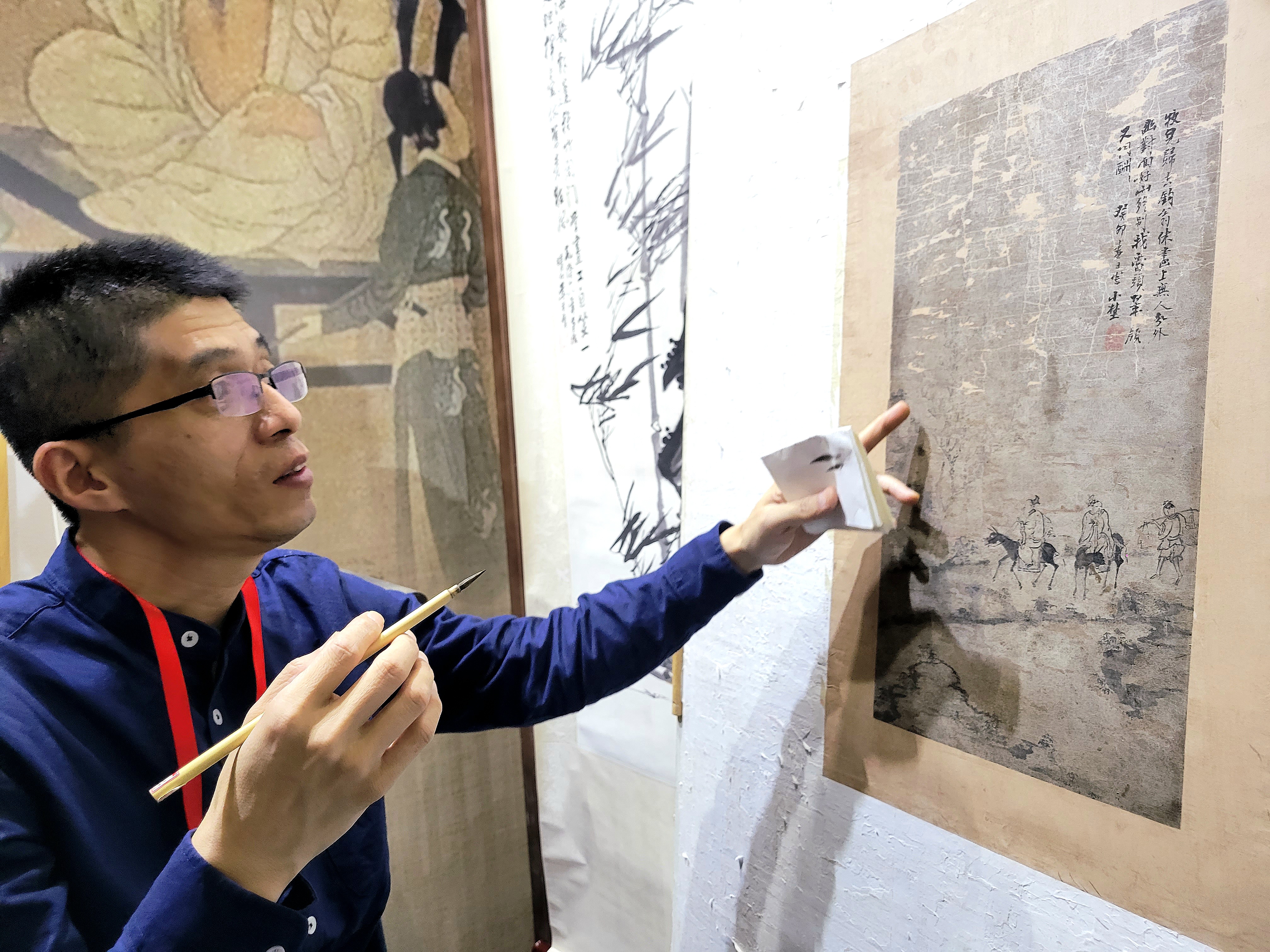 Συντηρητής αρχαίων έργων ζωγραφικής στην 1η Διεθνή Εβδομάδα Άυλης Πολιτιστικής Κληρονομιάς στο Πεκίνο, 22 Οκτωβρίου 2023. (Φωτογραφία: Εύα Παπαζή/CRI Greek)